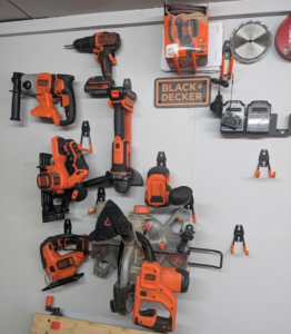 Black and Decker tools organised on a workshop wall